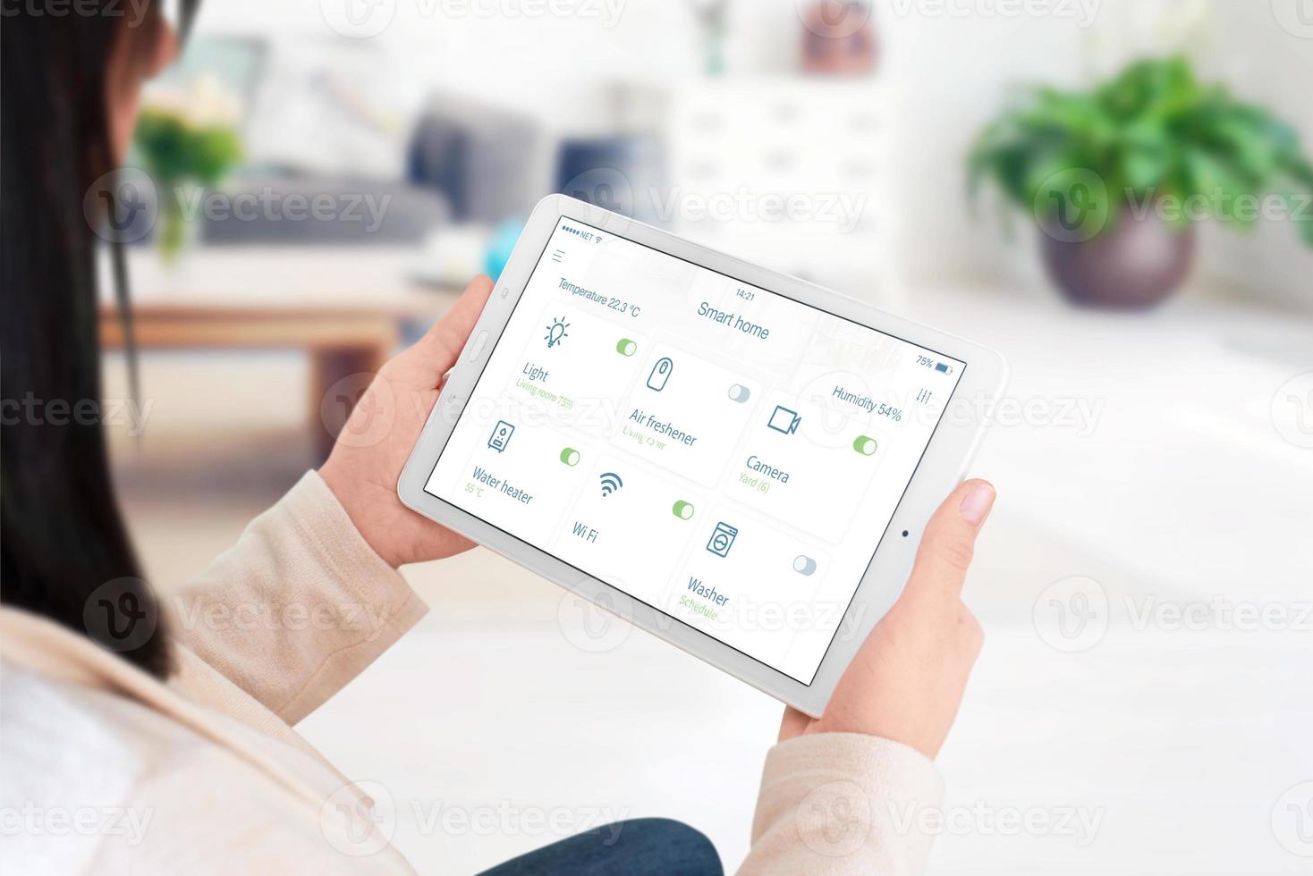 Home devices control on modern smart home app on tablet display in woman hand concept photo