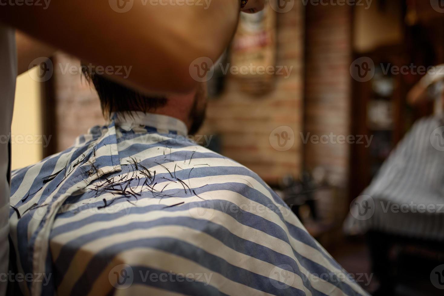 male hair cut while cutting on an apron photo