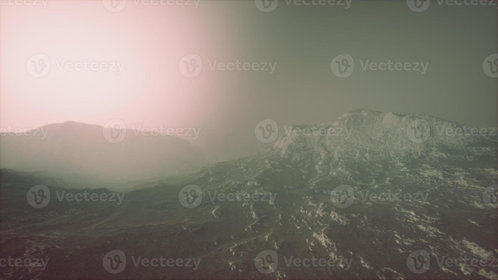 Rocks and mountains in deep fog photo