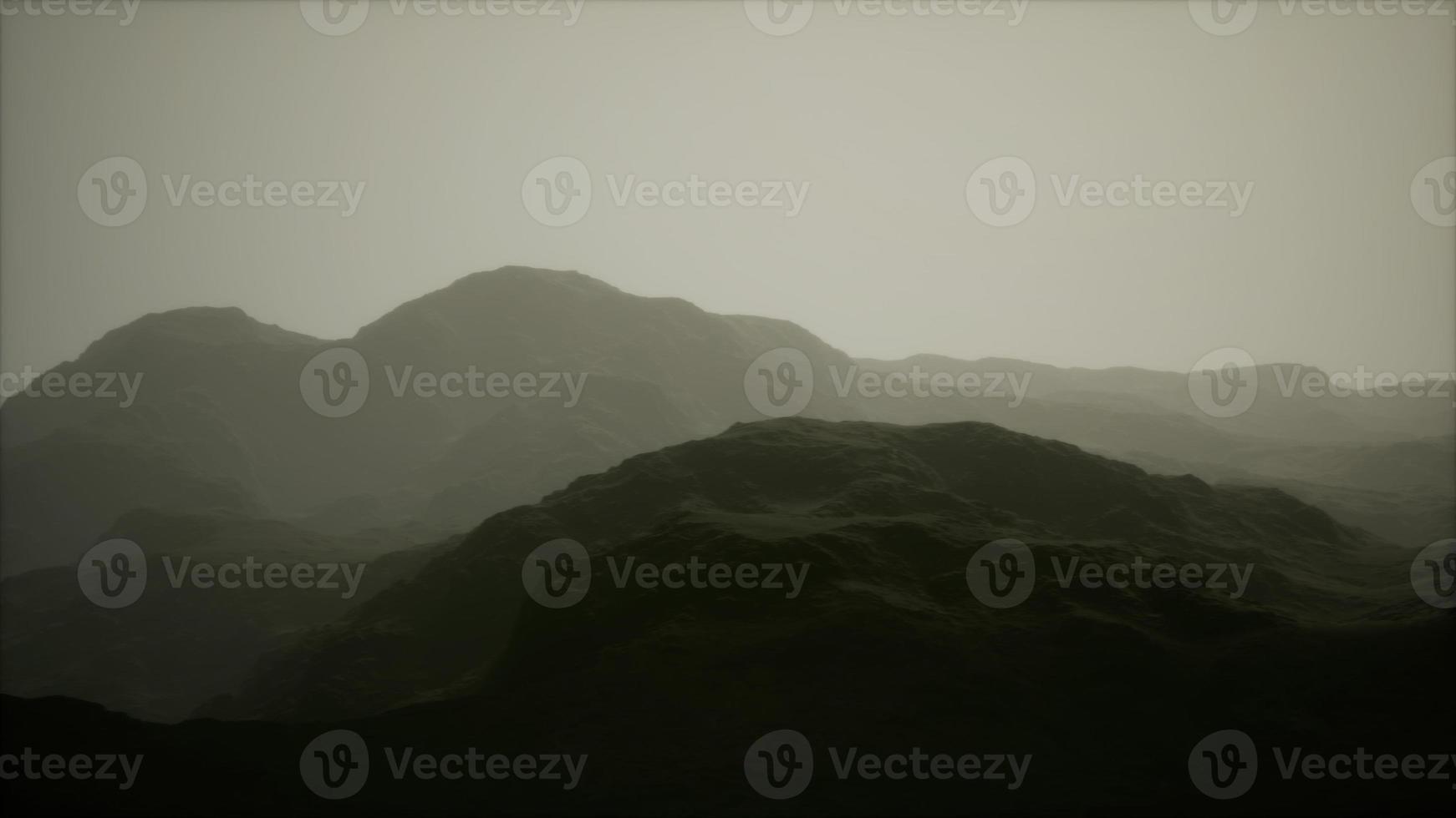 silhouette of swiss alps mountains in morning clouds photo