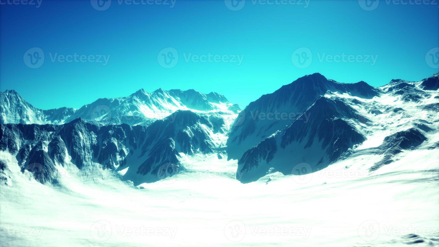 panoramic mountain view of snow capped peaks and glaciers photo