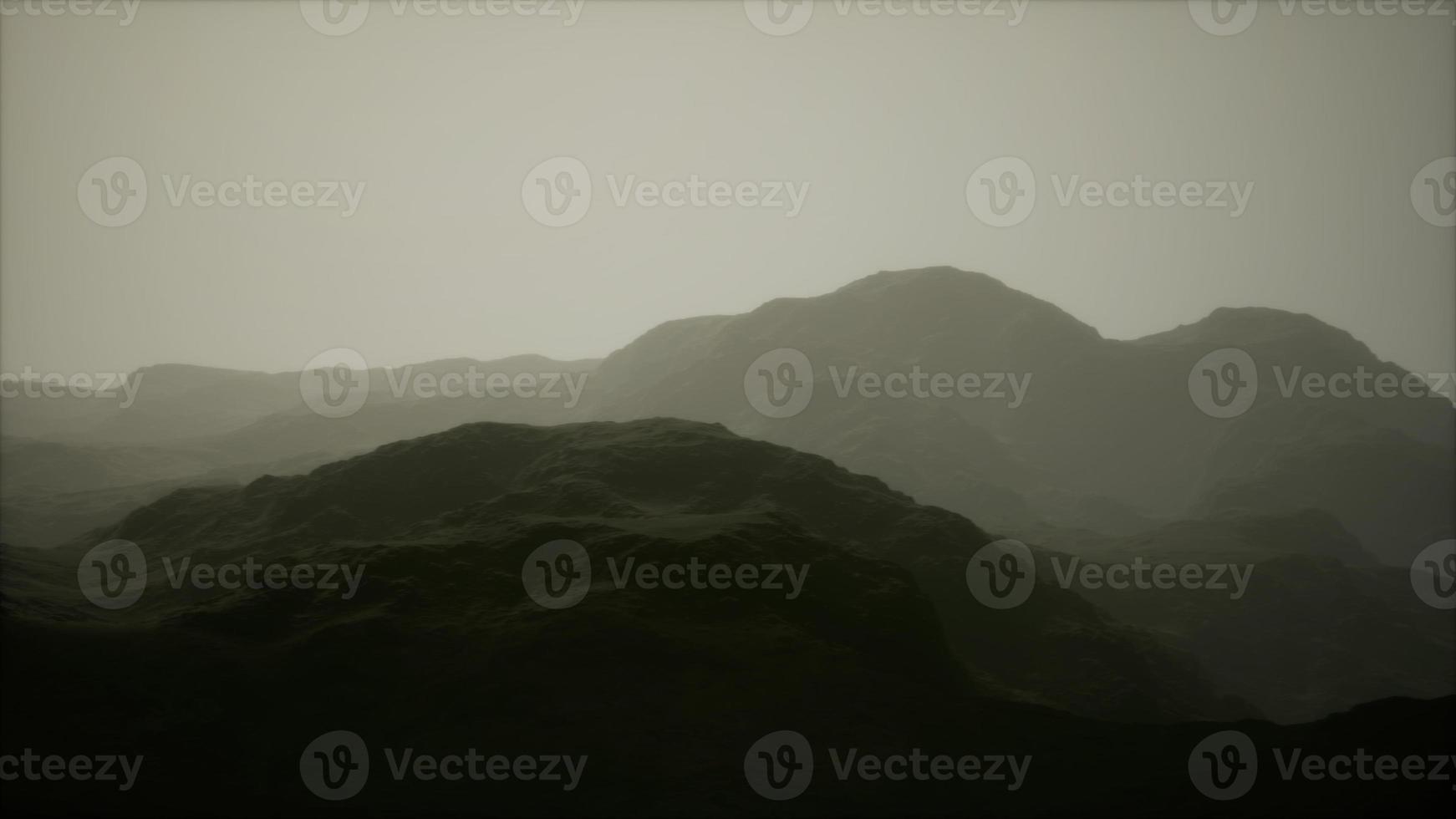 Rocks and mountains in deep fog photo