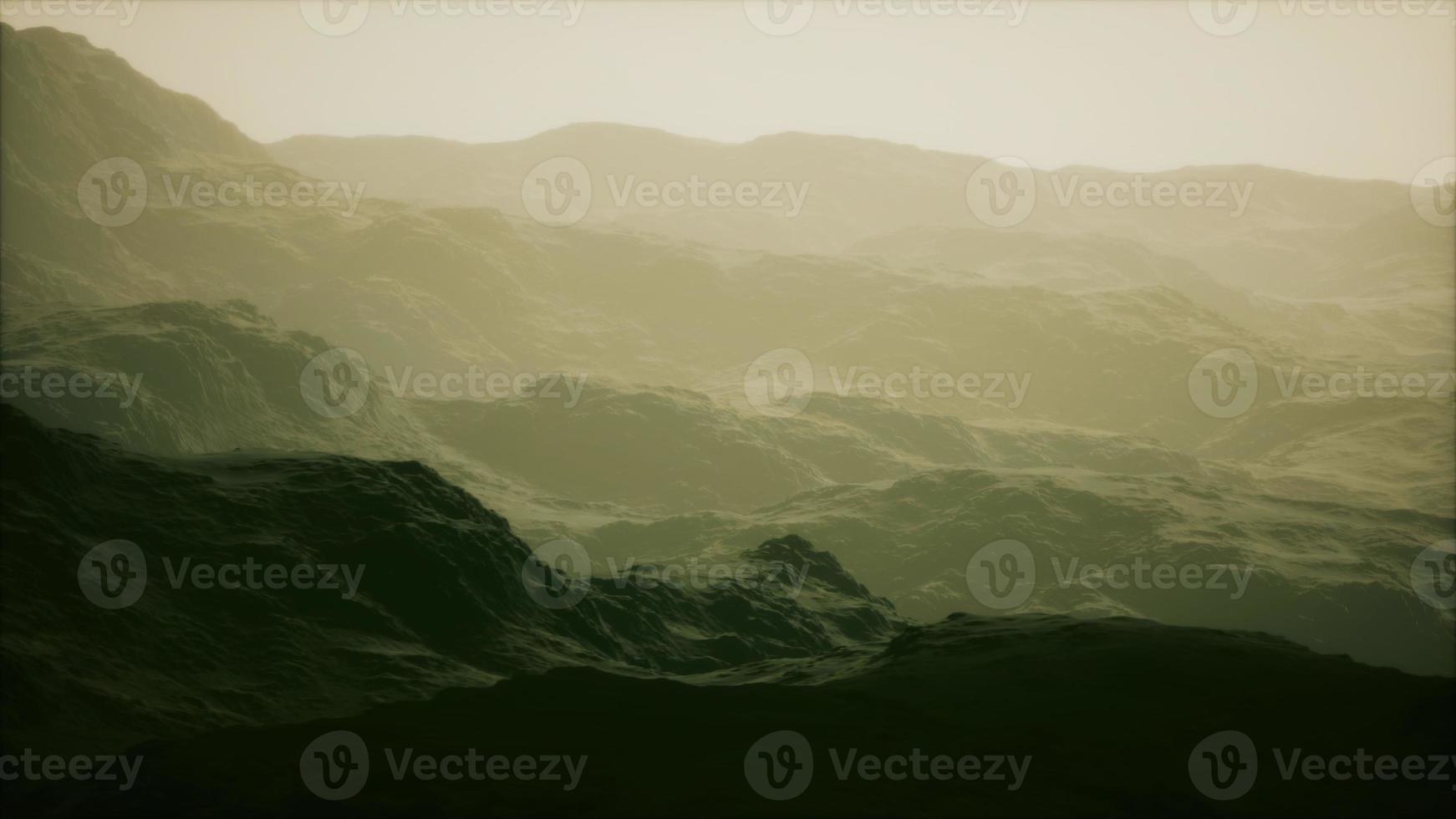 silhouette of swiss alps mountains in morning clouds photo