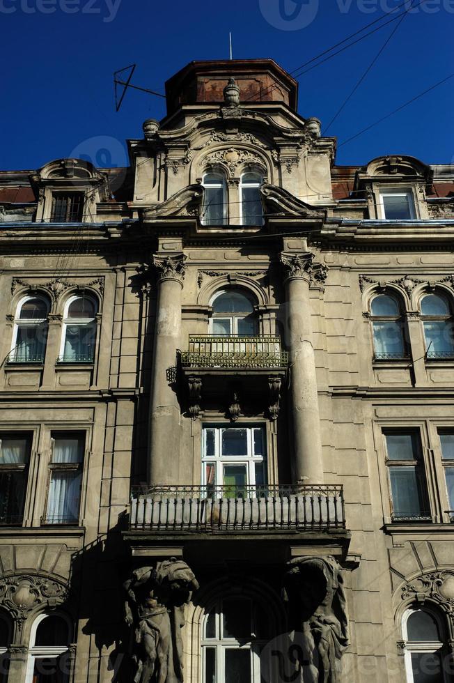 Building facade. Old building exterior with windows and lanterns. Historic building structure. Architectural structure. Urban architecture and construction. City building. Town house. photo