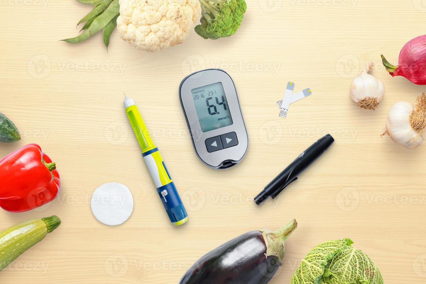 Diabetes concept composition with blood glucose meter and insulin surrounded by healthy food, vegetables. Top view, flat lay photo