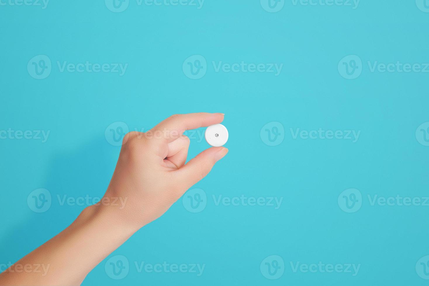 Hand holds a blood glucose sensor. Concept of modern diabetes control technology photo