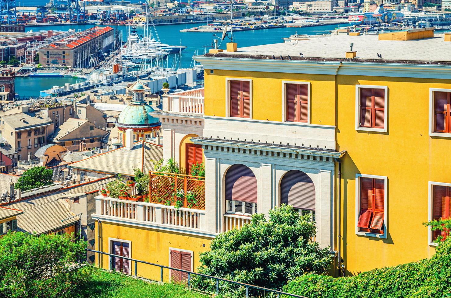 Top aerial view of Genova city old historical centre quarter with yellow walls building, port and harbor of Ligurian and Mediterranean Sea photo