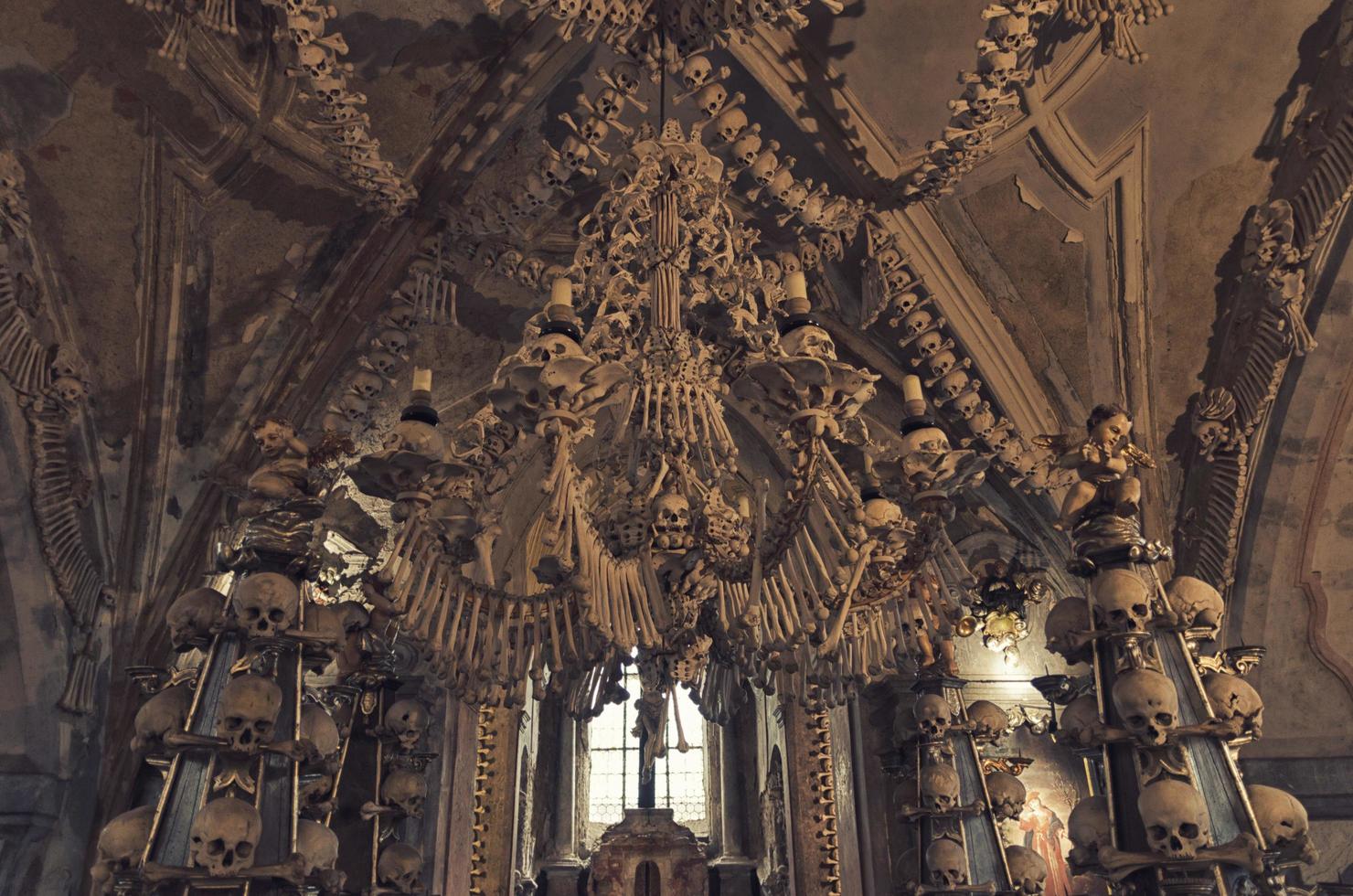 Kutna Hora Church with colonnade of human bones and skulls photo