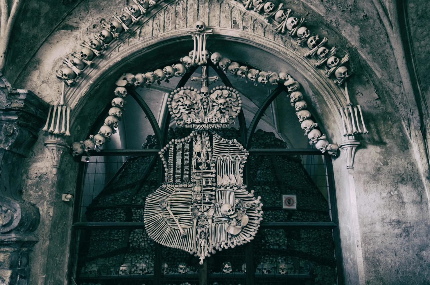 Kutna Hora Church with colonnade of human bones and skulls photo