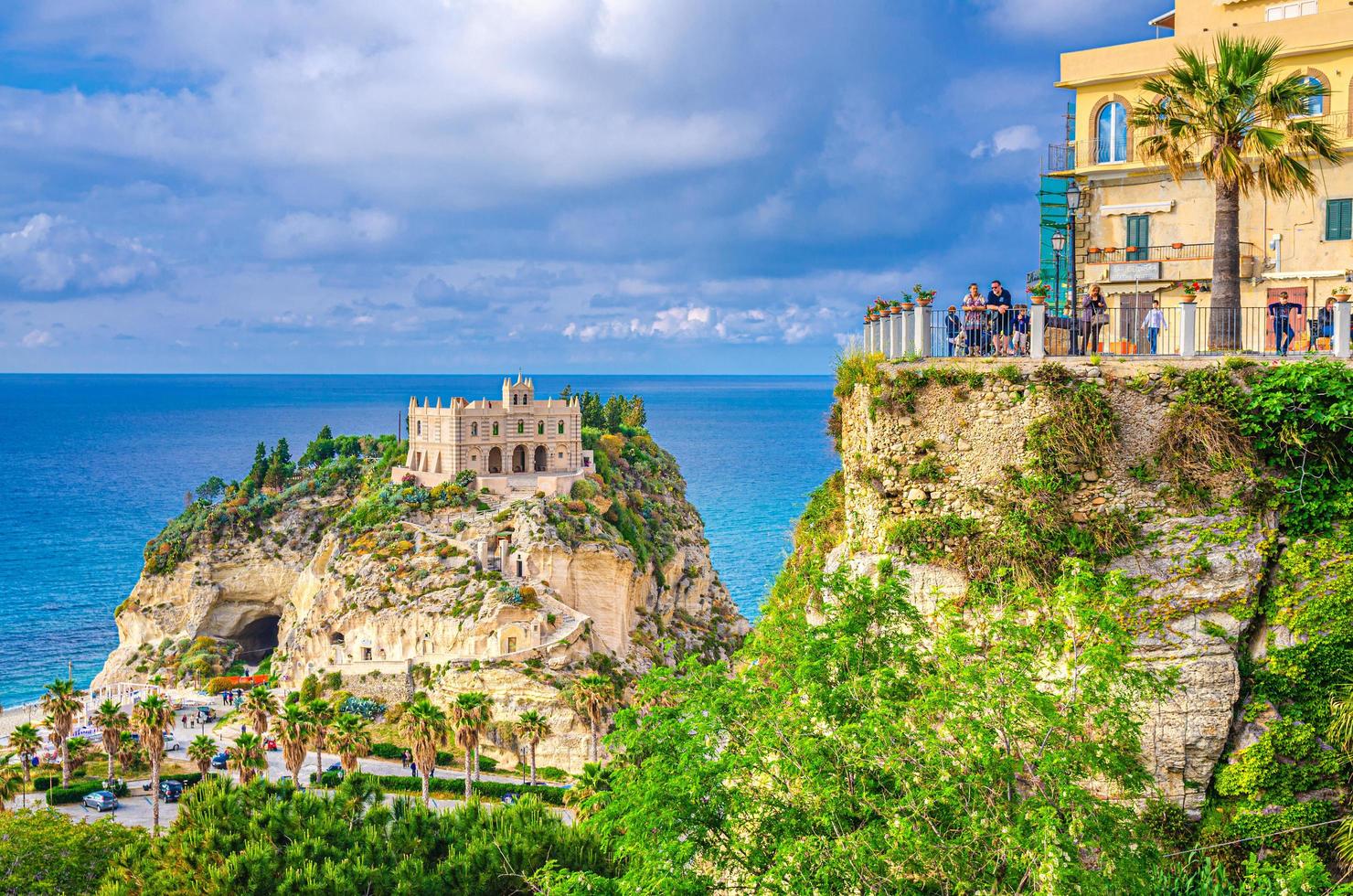 Tropea people tourists on observation deck view platform Belvedere Piazza del Cannone are looking at Monastery Sanctuary church photo