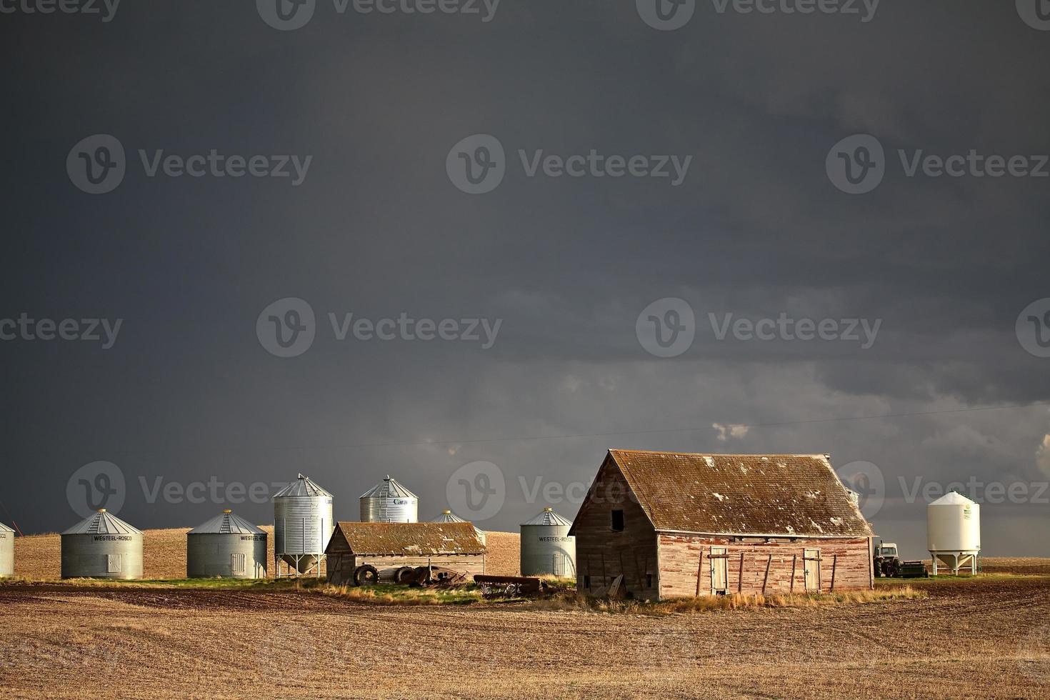 Storm clouds over farm buildings in Saskatchewan photo