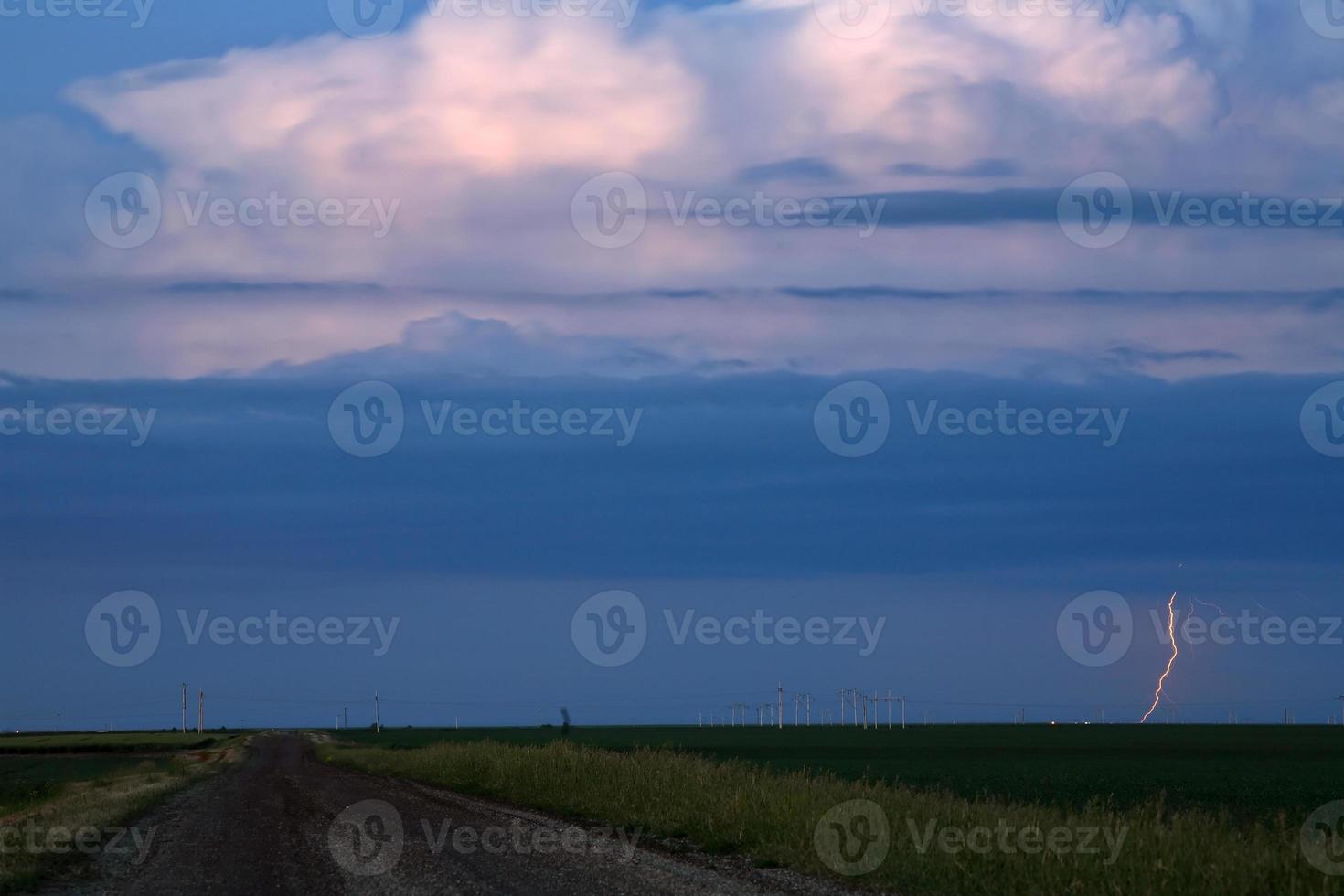 Lightning flashing from storm clouds in scenic Saskatchewan photo