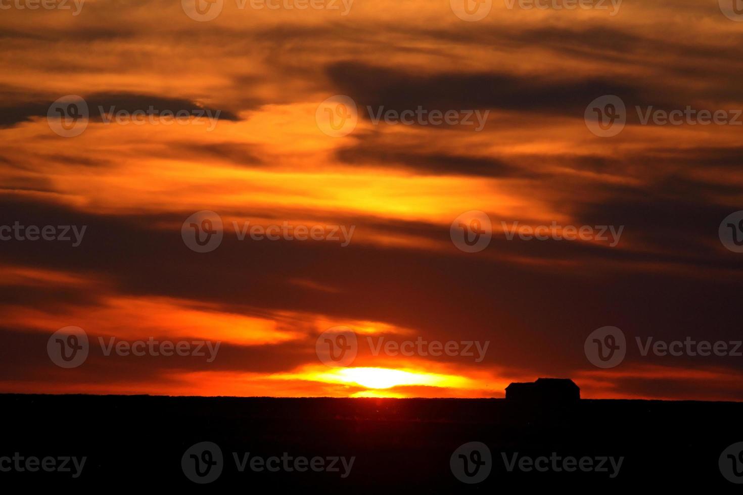 Sunset behind a Saskatchewan farm building photo