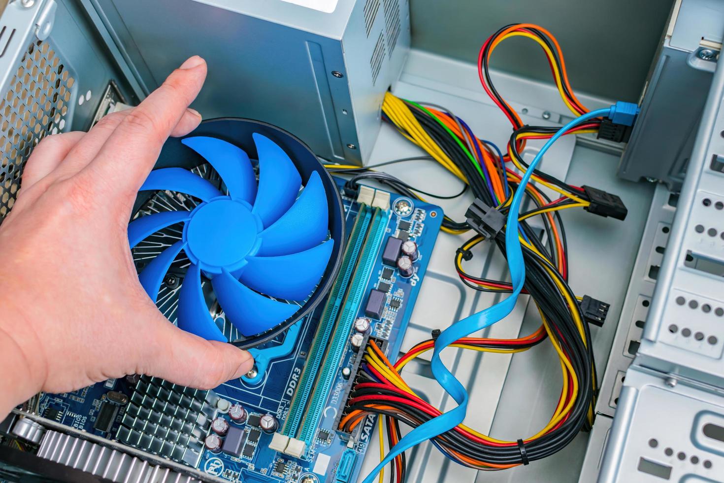 Installing a CPU fan on a computer motherboard photo