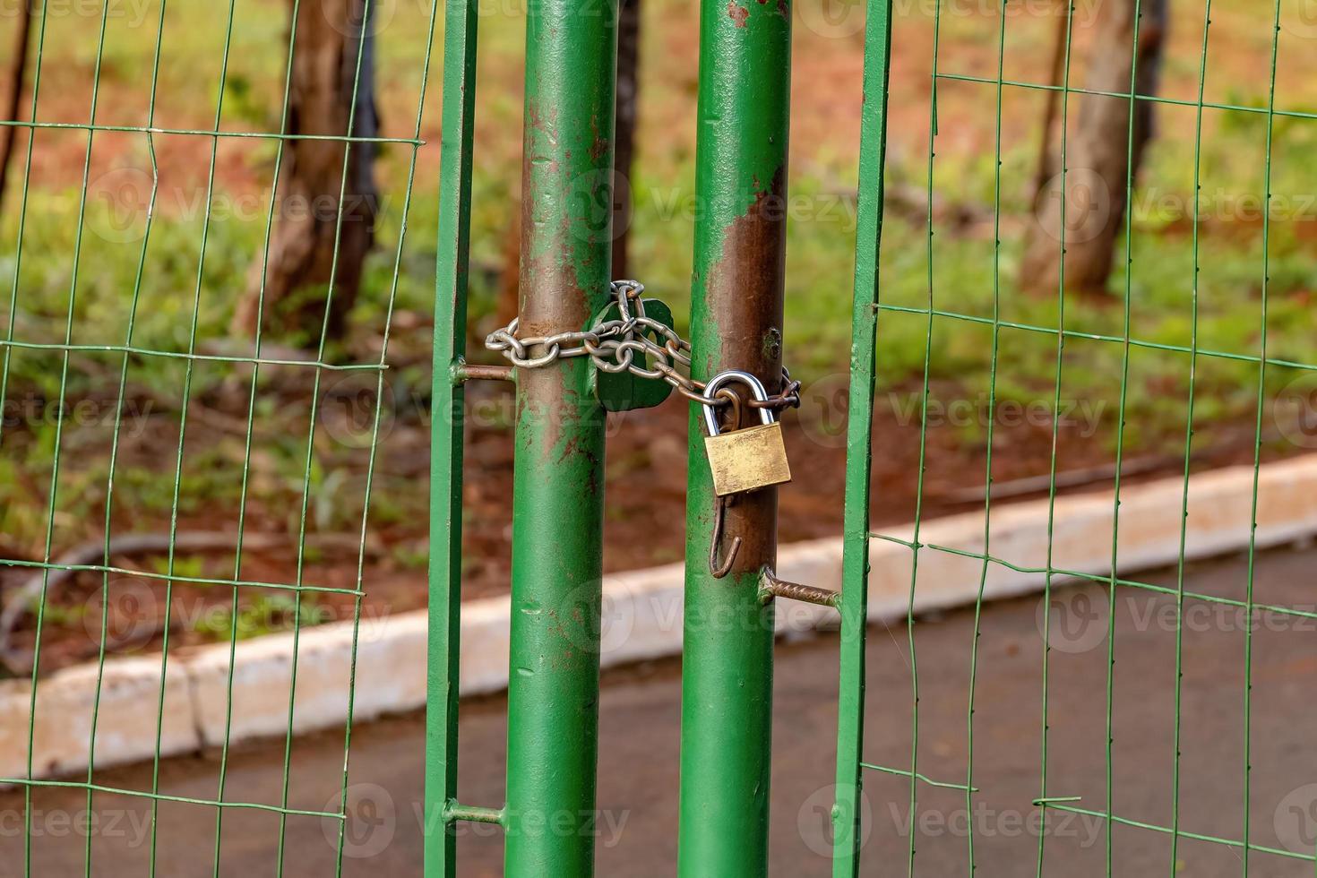 green metallic gate locked photo