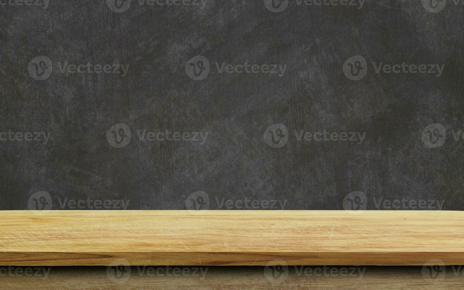 Empty wood table top on chalkboard background. photo