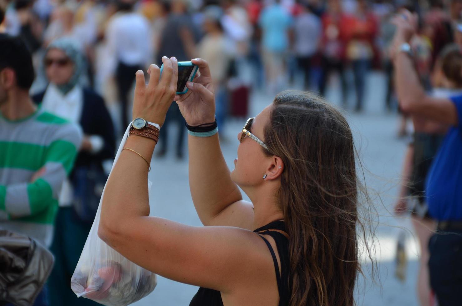 young woman photographed with cell phone photo