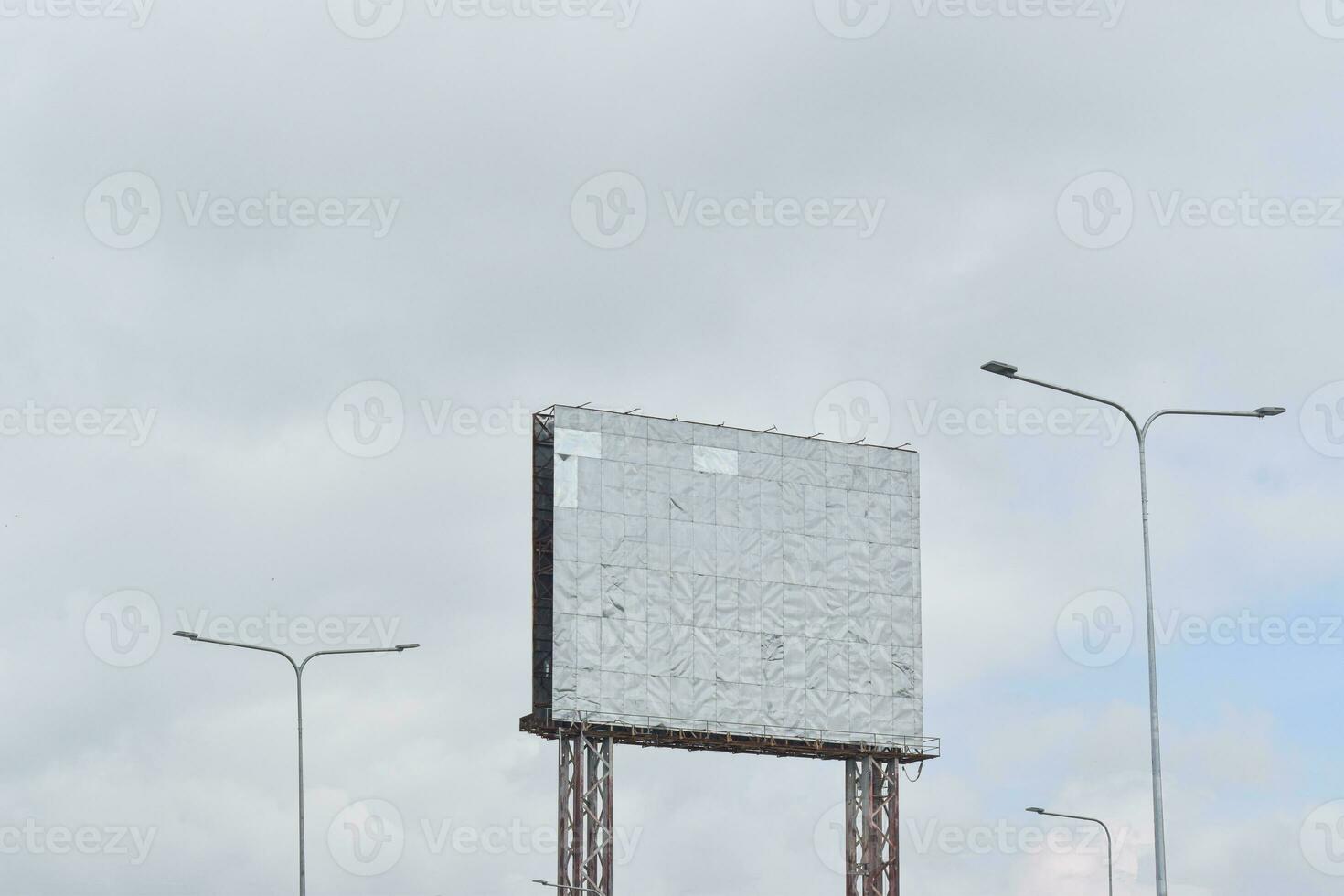 Old empty billboard stainless against blue sky background for advertisement or design. photo