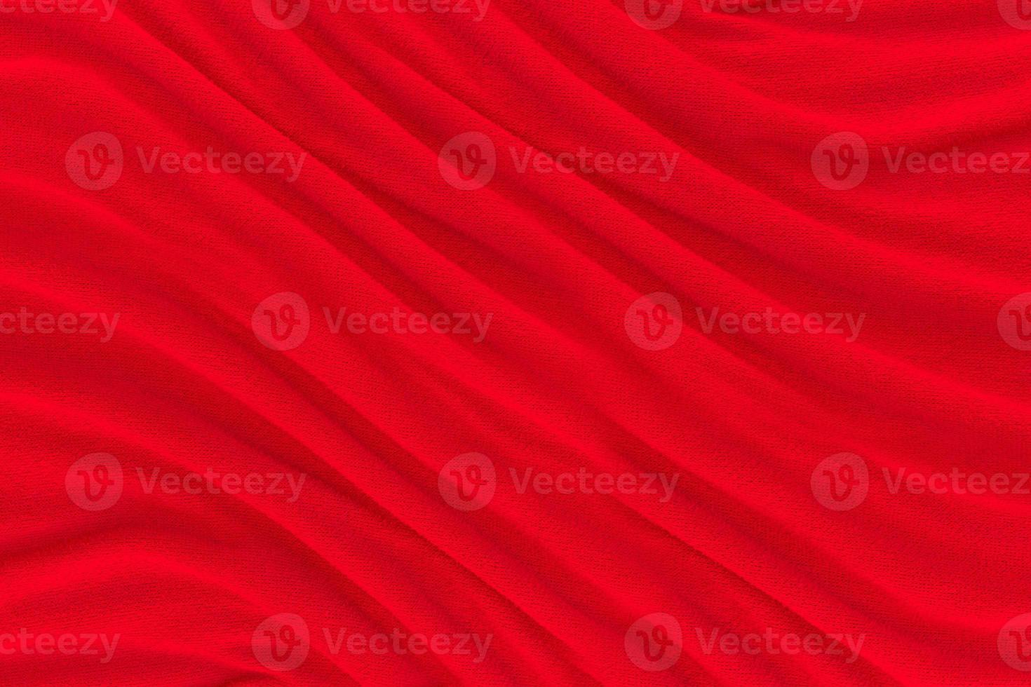 Red fabric texture background. Abstract cloth backdrop with soft waves. photo