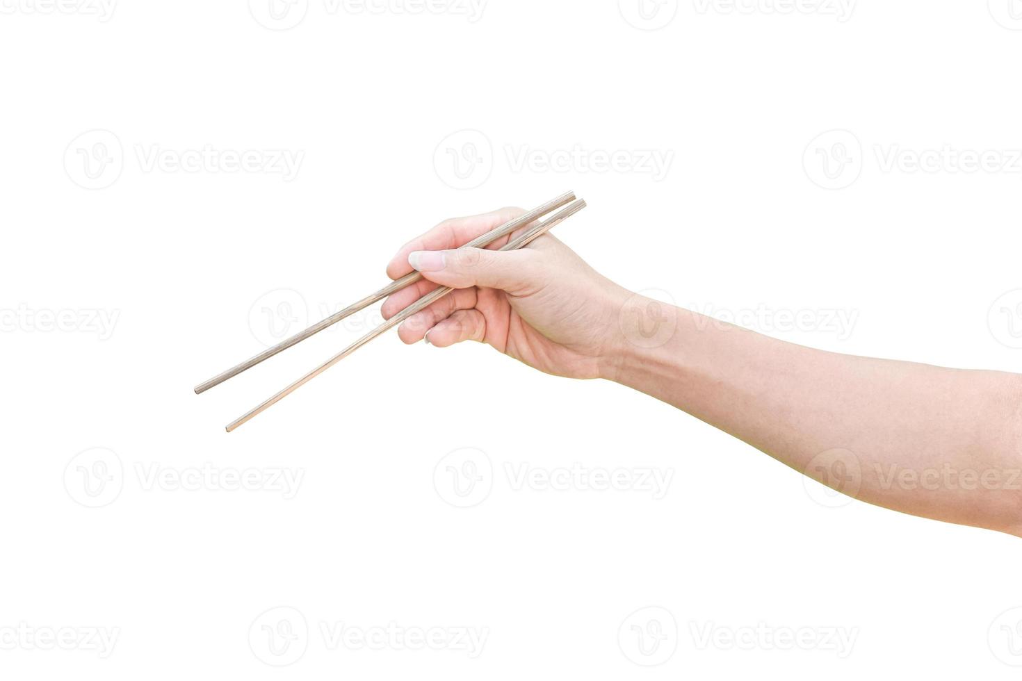 hand holding wooden chopsticks isolated on white background with clipping path. photo