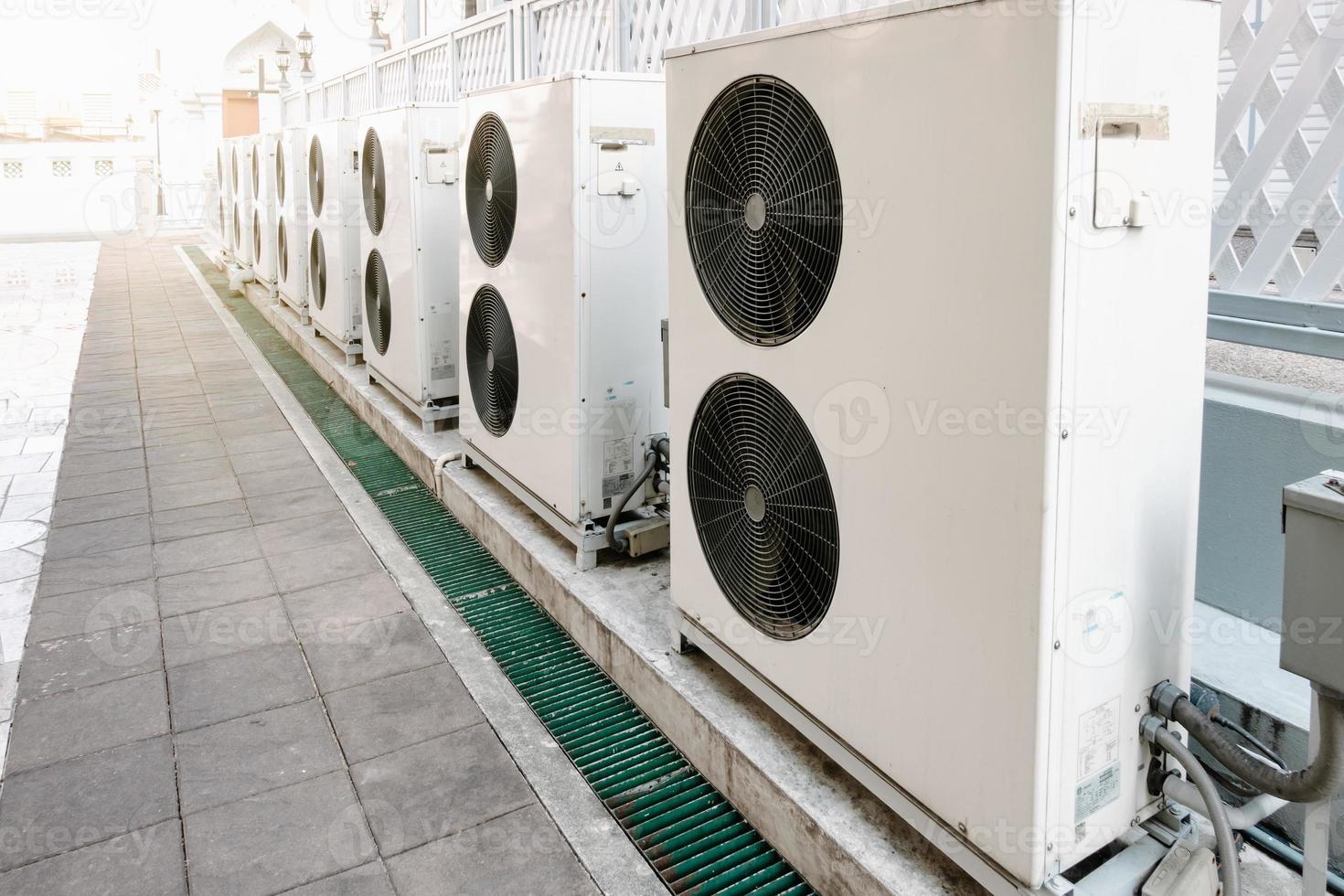 Cooling Air Condition Unit and Control System, Air Condenser Engine Station Outside Building of HVAC Systems. Electrical Compressor Fan Coil of Air Conditioning Equipment for Home Residential Units. photo