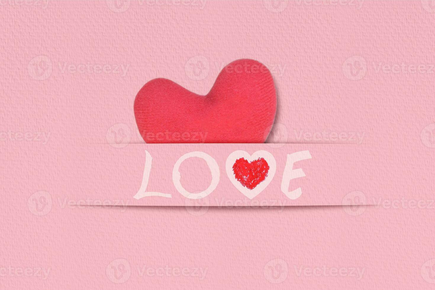 Red origami hearts with word love on pink paper background. Handcrafted card valentine's photo