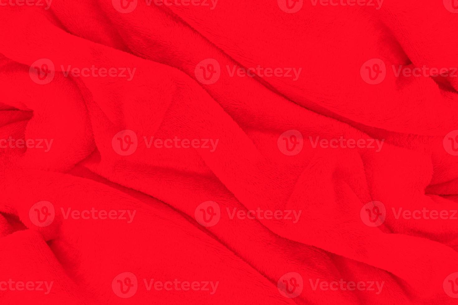 Red fabric texture background. Abstract cloth backdrop with soft waves. photo