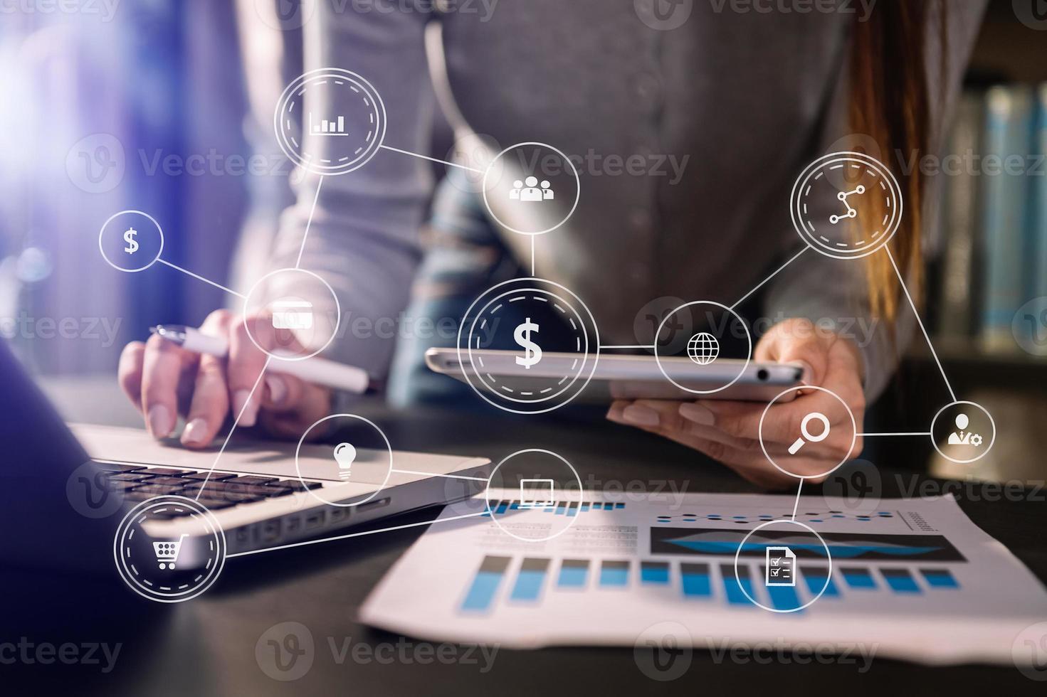 Businesswoman hand using laptop, tablet and smartphone  in office. Digital marketing media mobile app in virtual icon screen photo