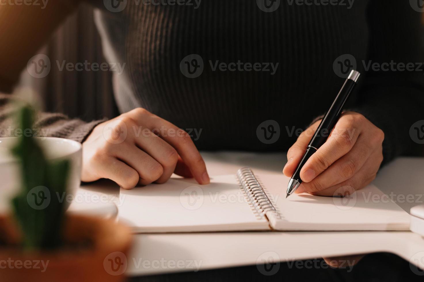 businessman hand working with new modern computer and writing on the notepad strategy diagram photo
