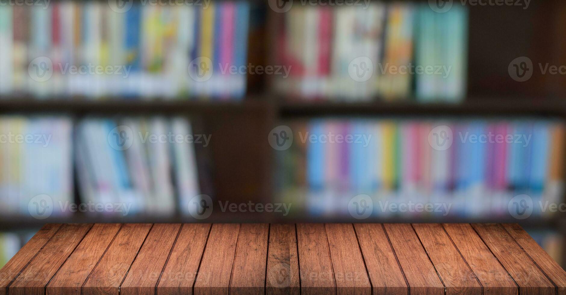 Empty wooden shelves over blurred bookshelf background. education concept. photo