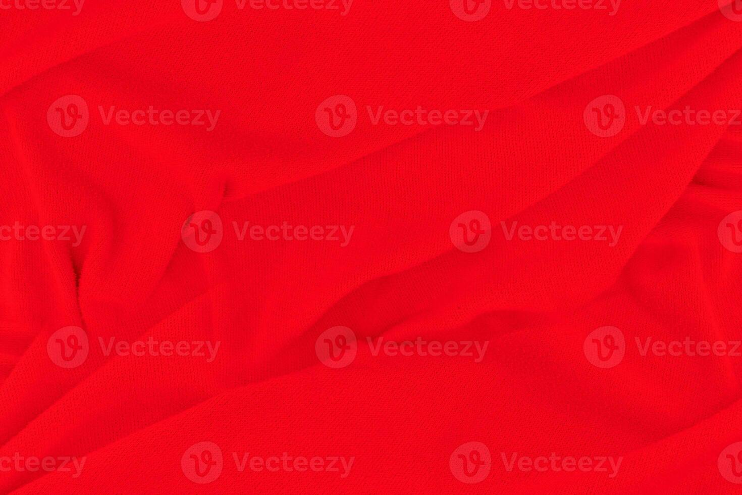 Red fabric texture background. Abstract cloth backdrop with soft waves. photo