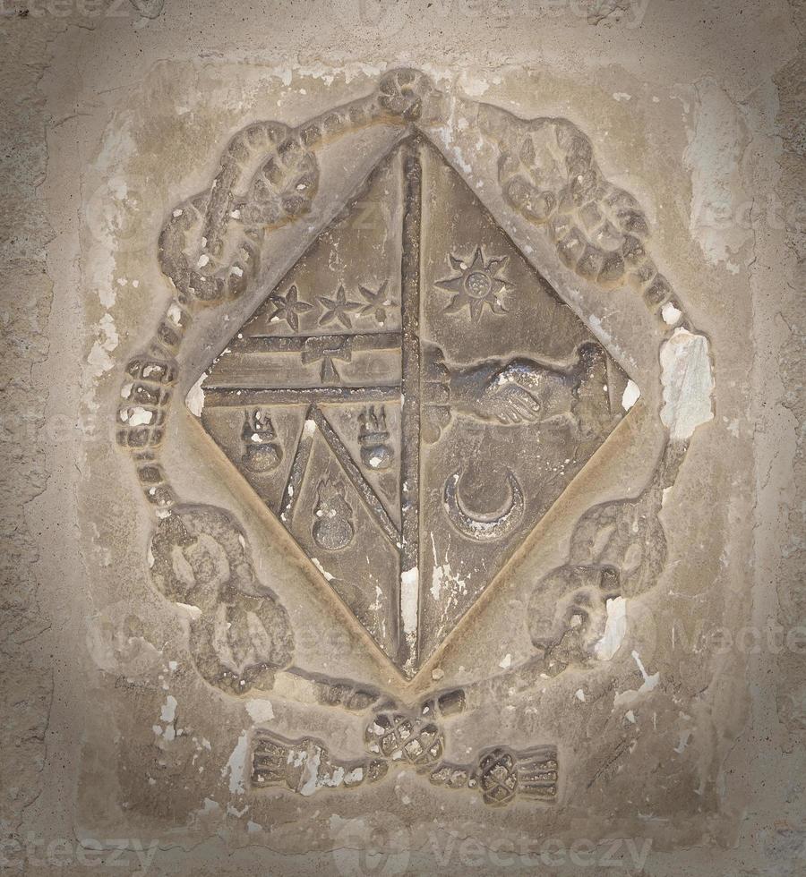 old coat of arms on the wall in the cathedral of Beziers photo