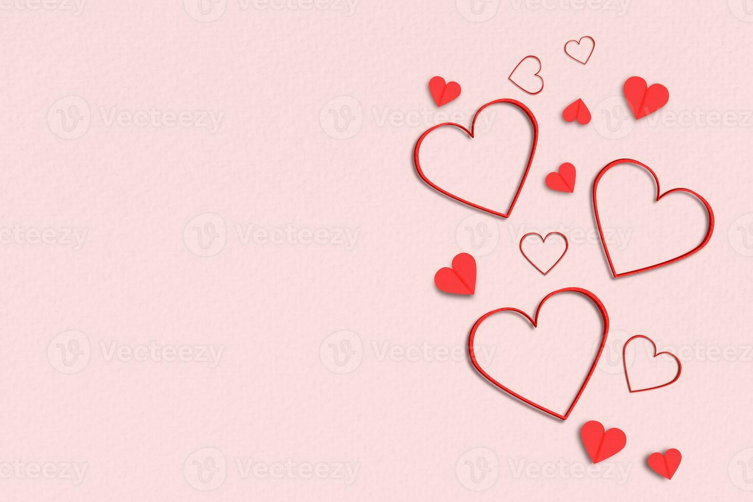 Flat lay red hearts on paper pink background. Composition for Valentine's Day photo