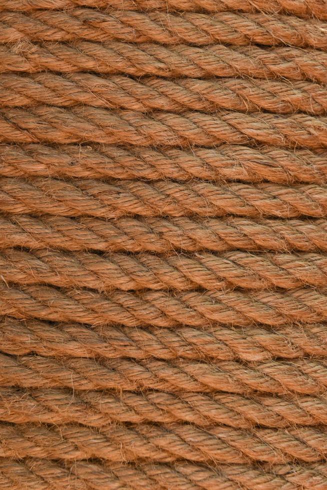 Close-up of coiled rope. Scum of the rope wrapped in rows. Texture of the fleecy rope, rows of packing twine. photo