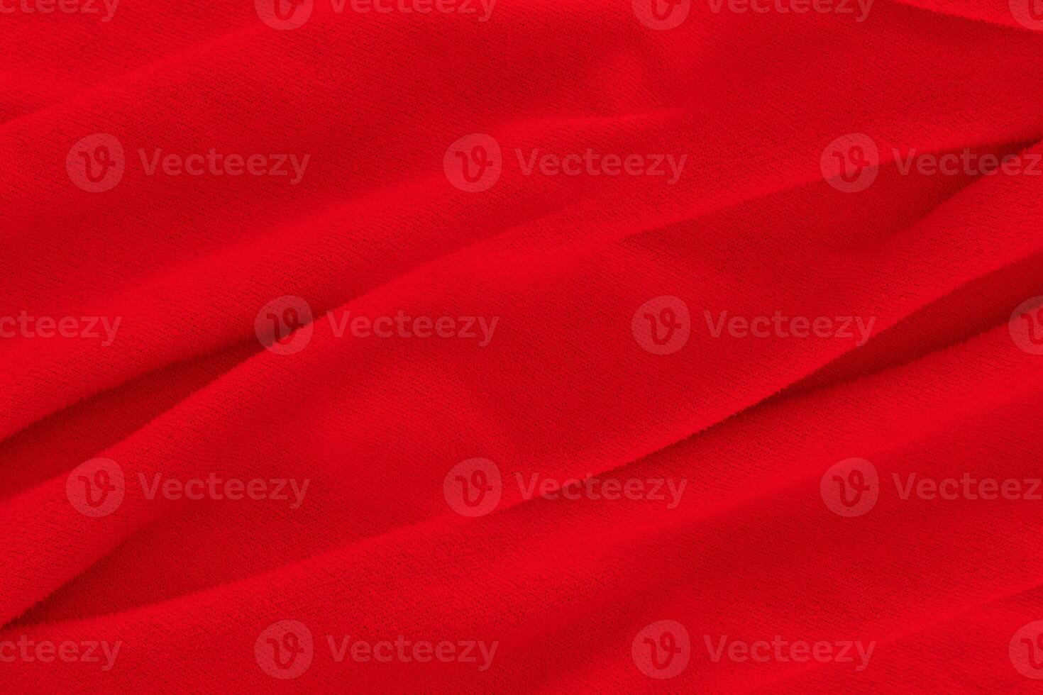 Red fabric texture background. Abstract cloth backdrop with soft waves. photo