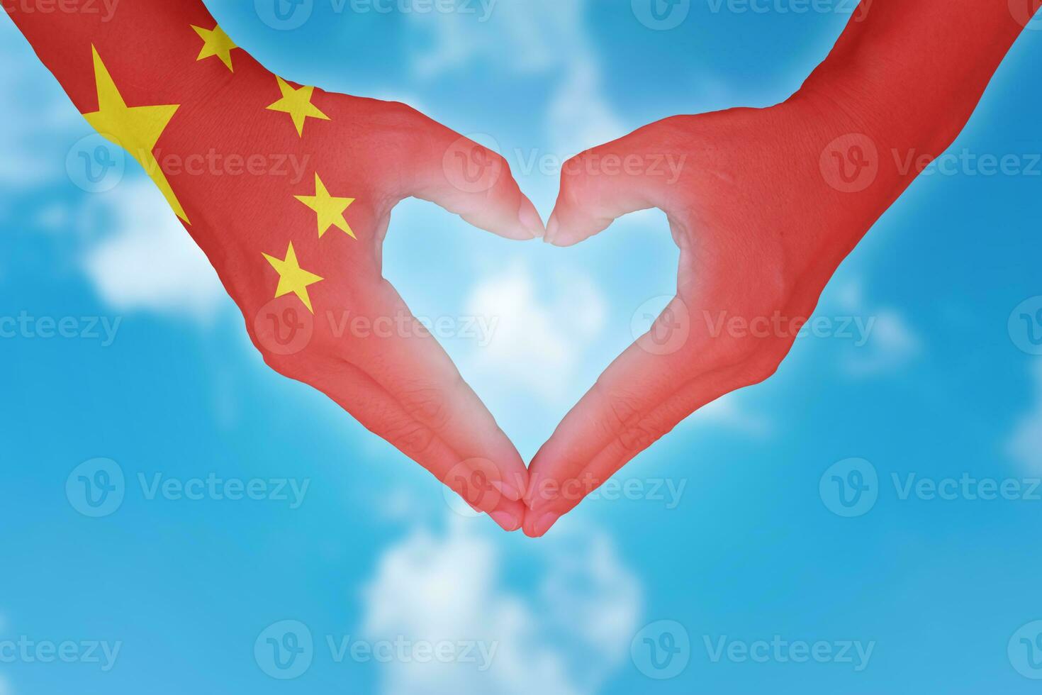 China flag painted on hands in heart shaped. photo