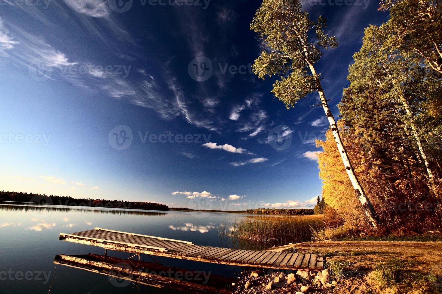 Boat dock and autumn trees along a Saskatchewan Lake 6277369 Stock Photo at Vecteezy