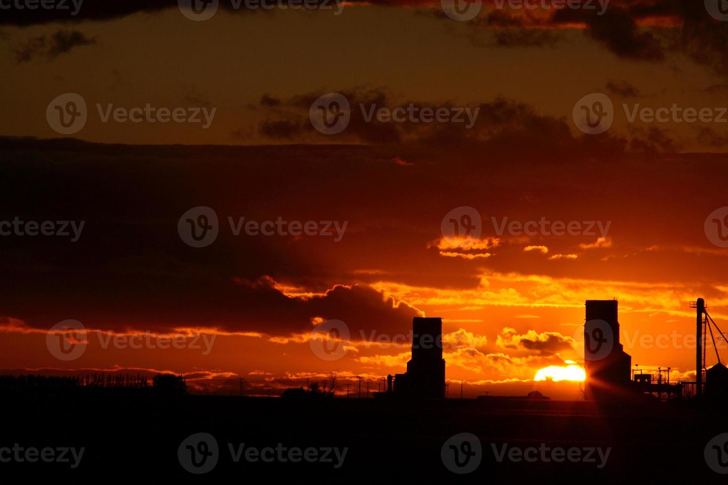 Sunset behind two Saskatchewan grain elevators photo