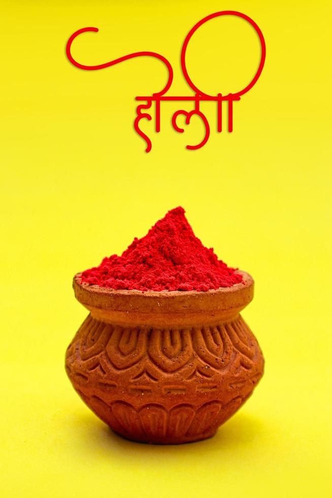 Indian festival Holi concept colour bowl with colorful background and writing holi in marathi calligraphy. photo