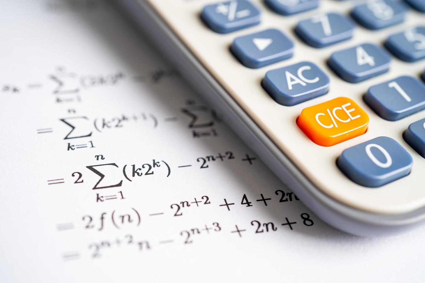 Pencil and calculator on mathematic formula exercise test paper in education school. photo