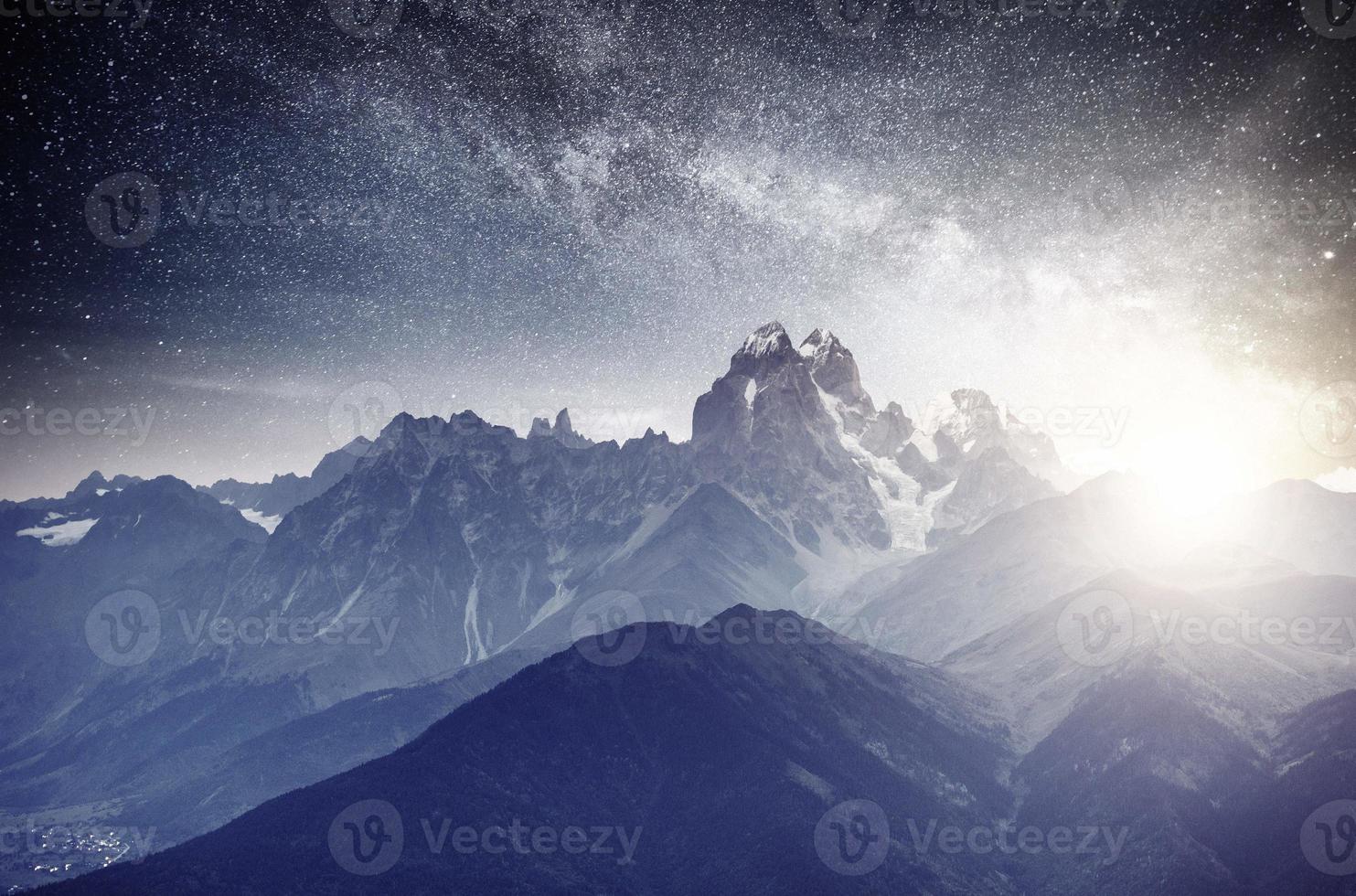 Fantastic starry sky. Autumn landscape and snow-capped peaks. Main Caucasian Ridge. Mountain View from Mount Ushba Meyer, Georgia. Europe photo