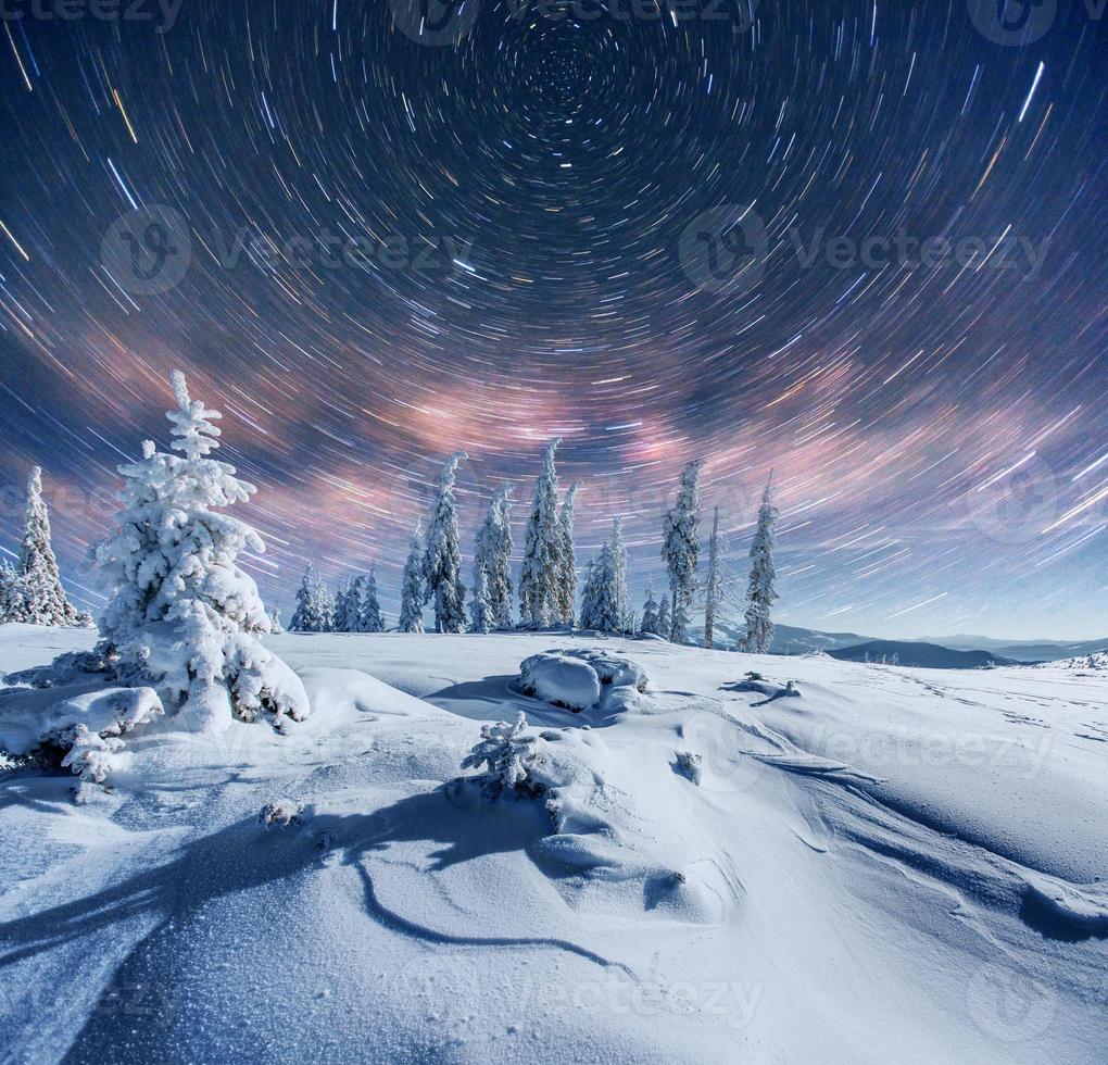 starry sky in winter snowy night. fantastic milky way in the New Year's Eve. In anticipation of the holiday. Dramatic scene. Carpathian. Ukraine photo