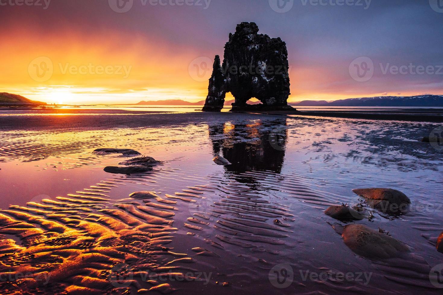 Is a spectacular rock in the sea on the Northern coast of Iceland. Legends say it is a petrified troll. On this photo Hvitserkur reflects in the sea water after the midnight sunset