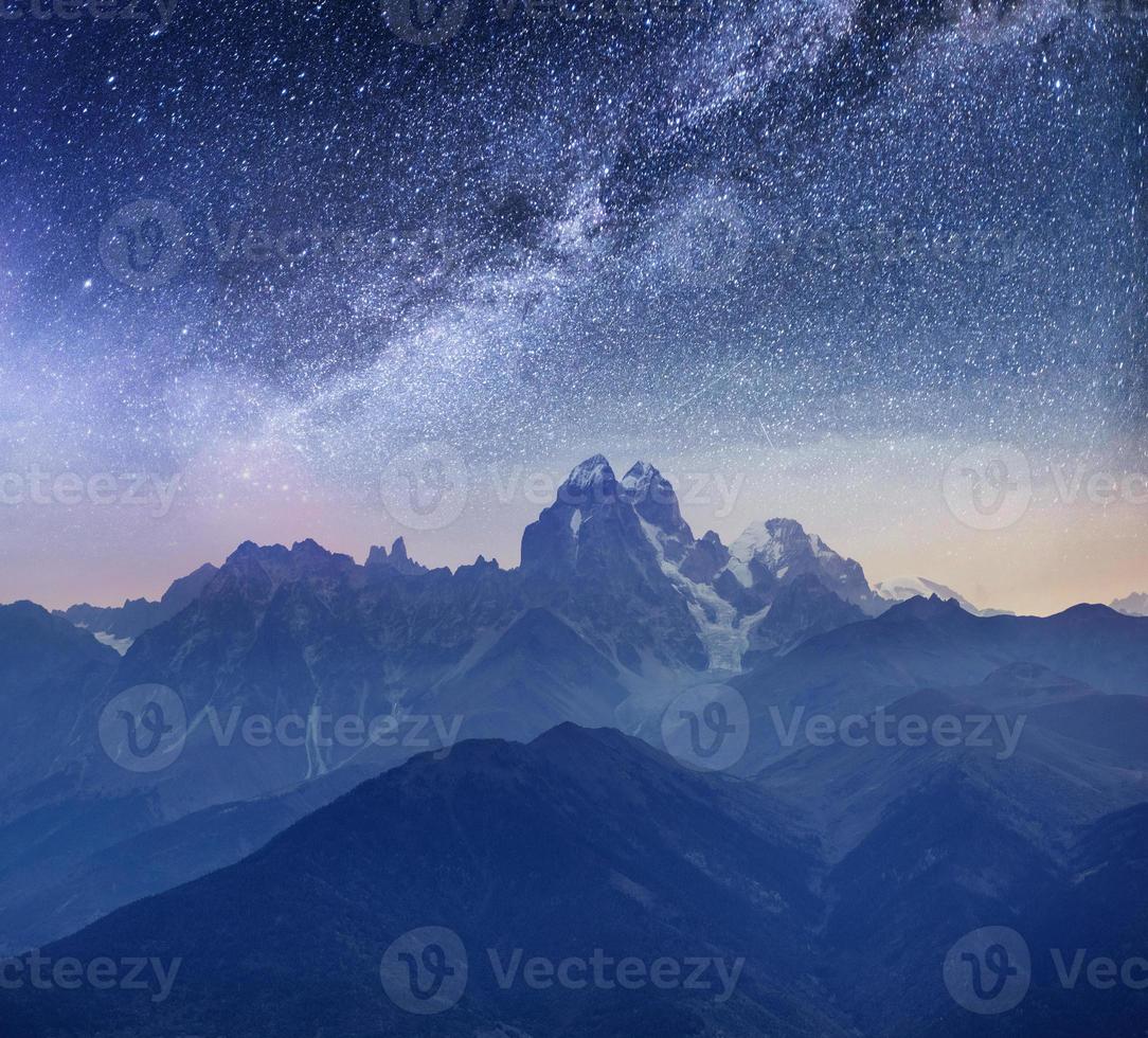 Fantastic starry sky. Snow-capped peaks. Main Caucasian Ridge. Mountain View from Mount Ushba Meyer, Georgia. Europe photo