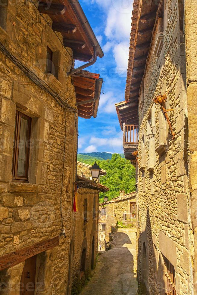 Beautiful view of scenic narrow alley with historic traditional houses and cobbled street in an old town in Europe with blue sky and clouds in summer with retro vintage photo