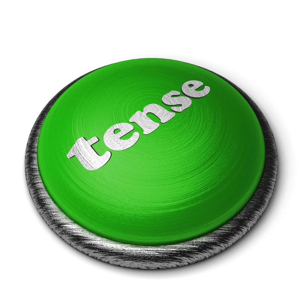 palabra tensa en el botón verde aislado en blanco foto