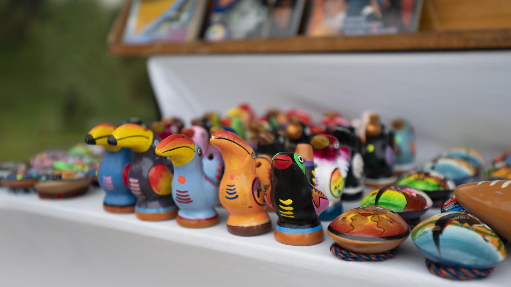 Quito, Ecuador, 2022 - Group of multicolored ceramic toucans made by hand by indigenous Ecuadorians for sale in an artisan market photo