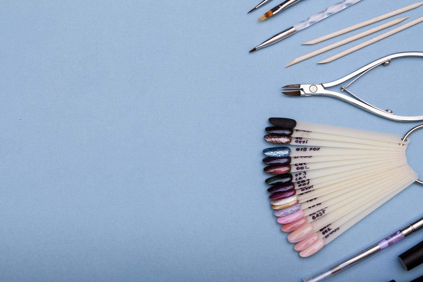 Professional tools for creating manicure. Flat lay on a blue background. Copy space photo