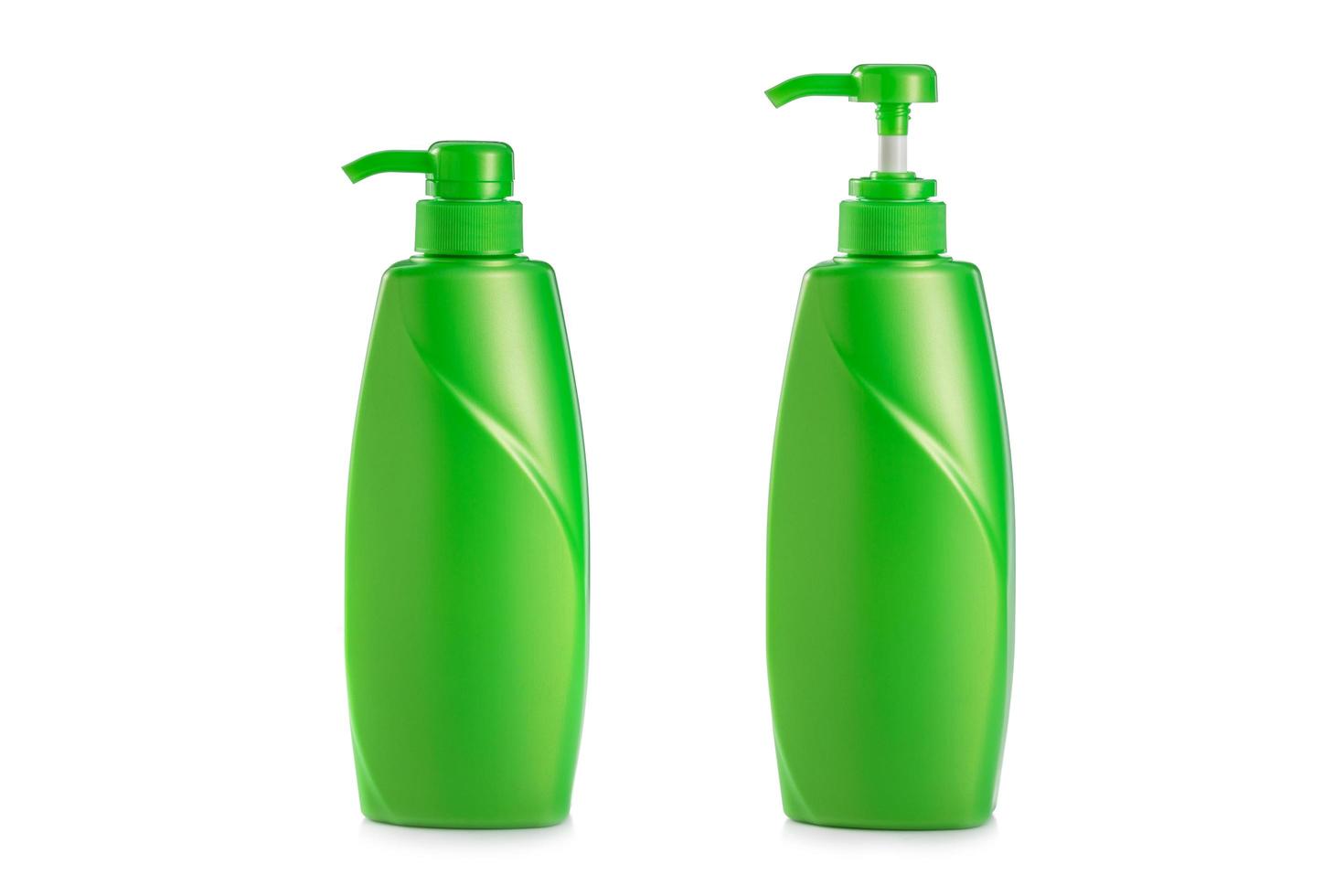 Blank green plastic pump bottle used for shampoo or soap. Studio shot isolated on white photo