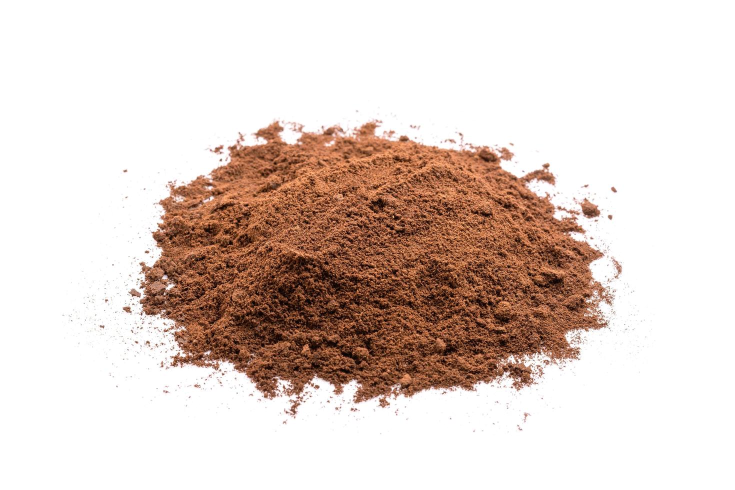 Ground coffee from coffee machine isolated on white background photo